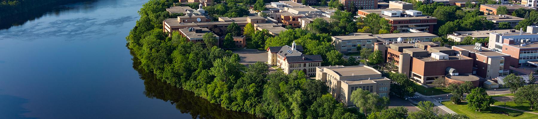 Aerial view of campus by river